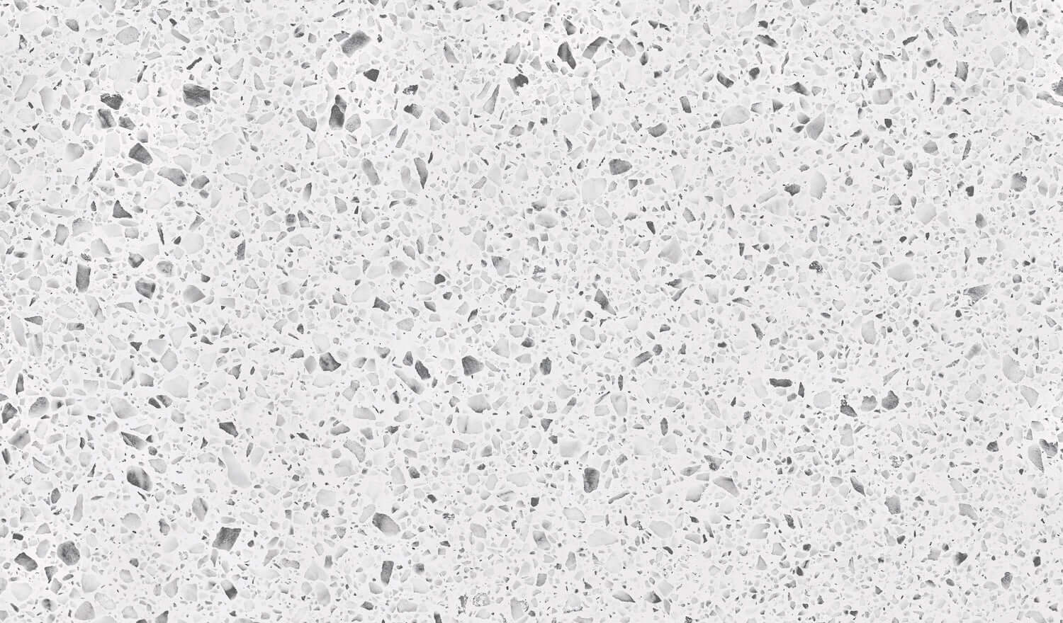 Close-up texture of a light gray and white speckled surface, resembling granite, ideal for kitchen countertops.