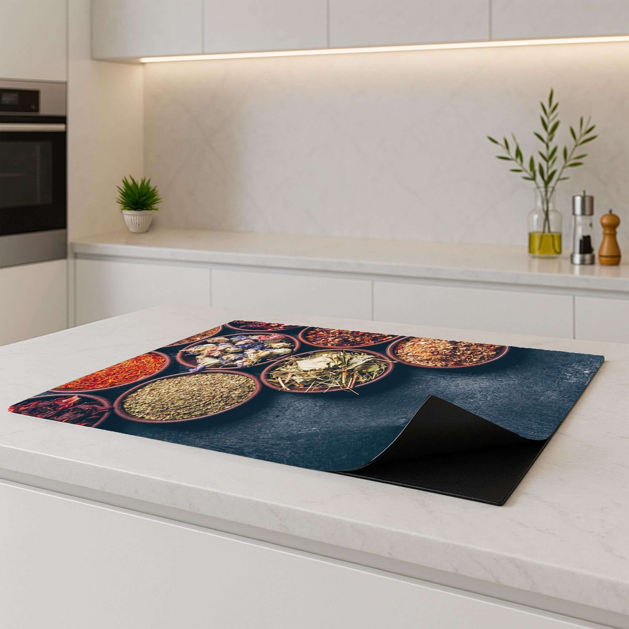 Herbal Market Inductie Beschermer on a kitchen counter, showcasing vibrant spices for protection against spills.
