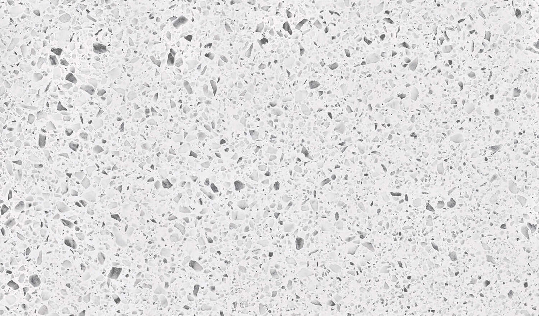 Close-up texture of a light gray and white speckled surface, resembling granite, ideal for kitchen countertops.