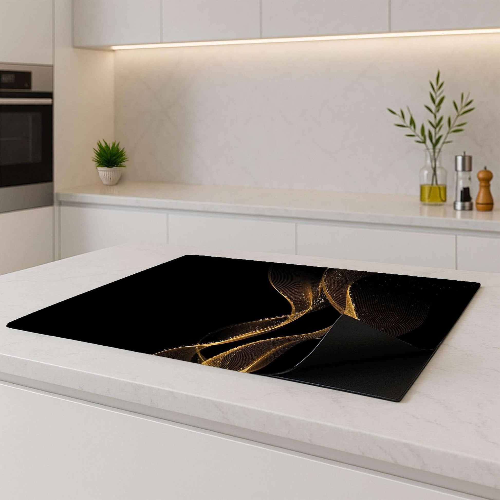 Golden Flow inductie beschermer – luxe zwart-goud design op een licht keukenblad, met opgerolde hoek