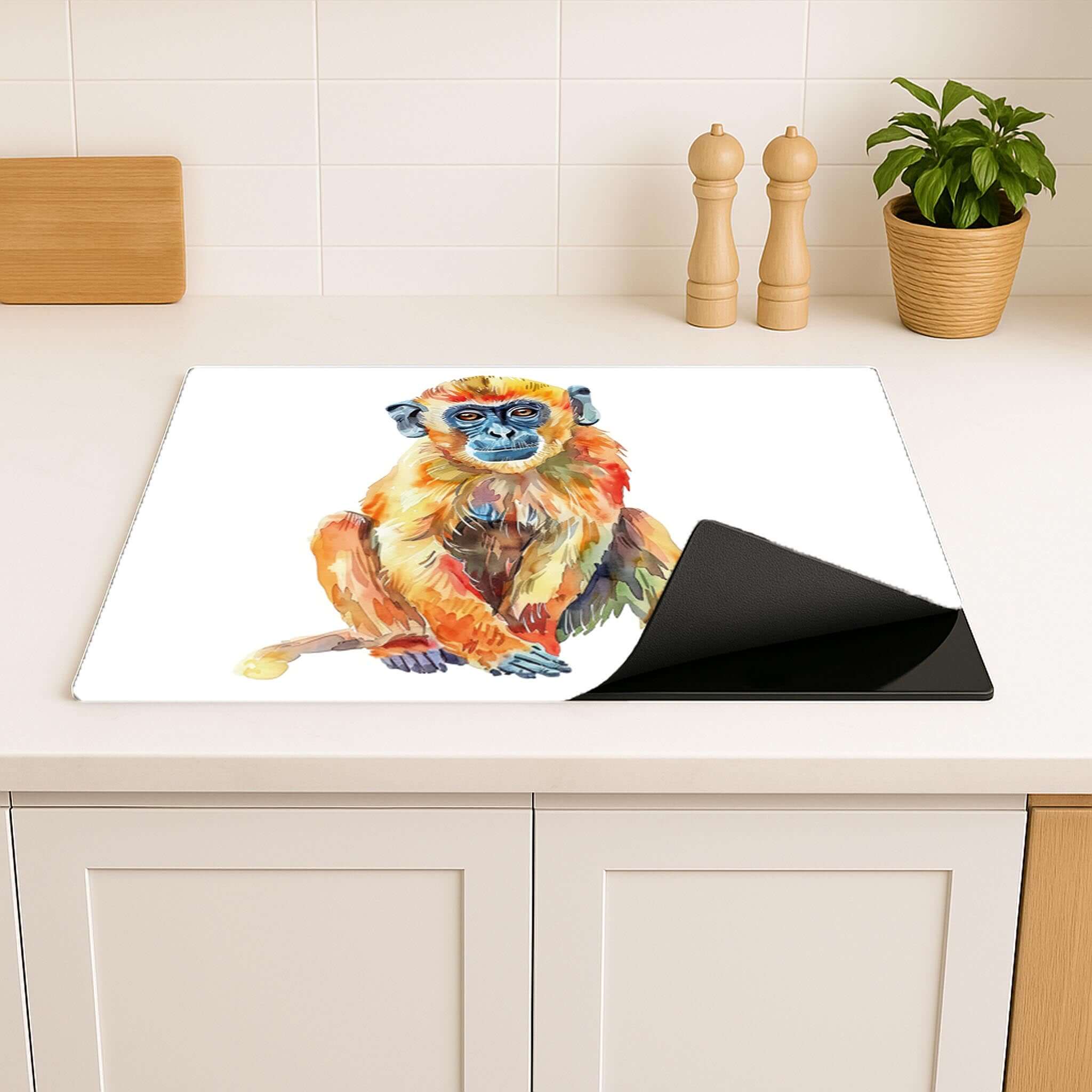 Kookplaat beschermer met kleurrijk apenmotief, opgerold en gebruiksklaar in de keuken