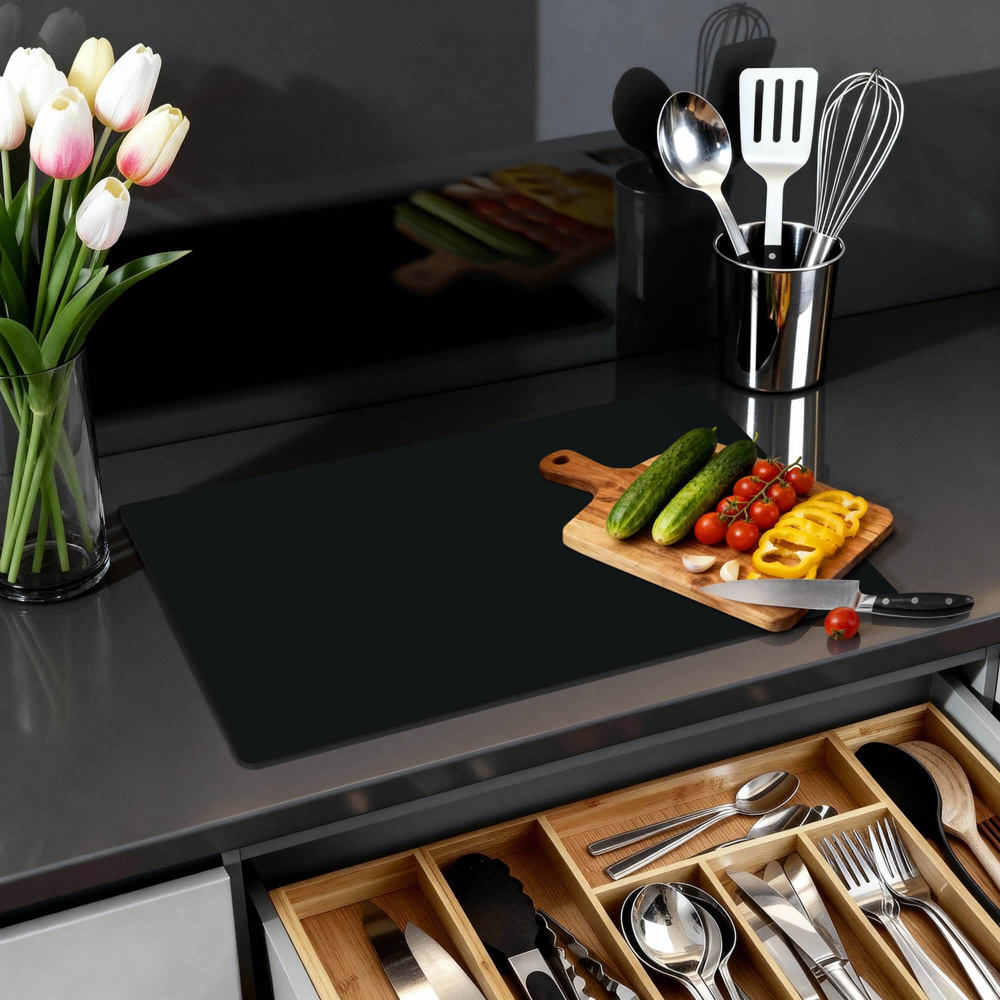 Pure Black – Inductie Beschermer op een moderne keukenblad met verse groenten en een stijlvolle opstelling.