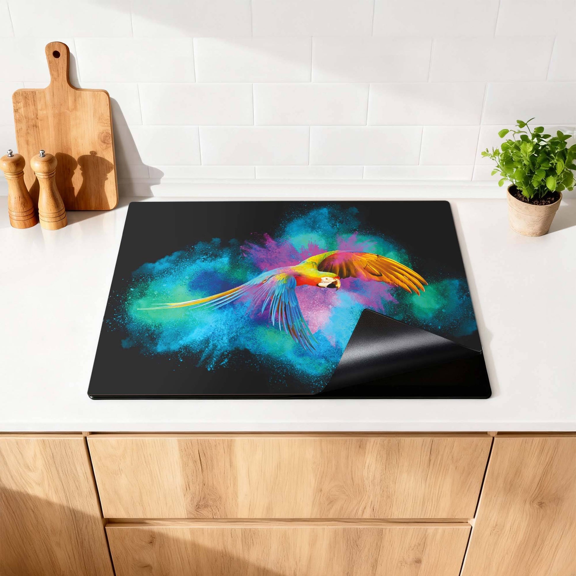 Color Flight – Inductie Beschermer met kleurrijke papegaai en levendige achtergronden in de keuken.