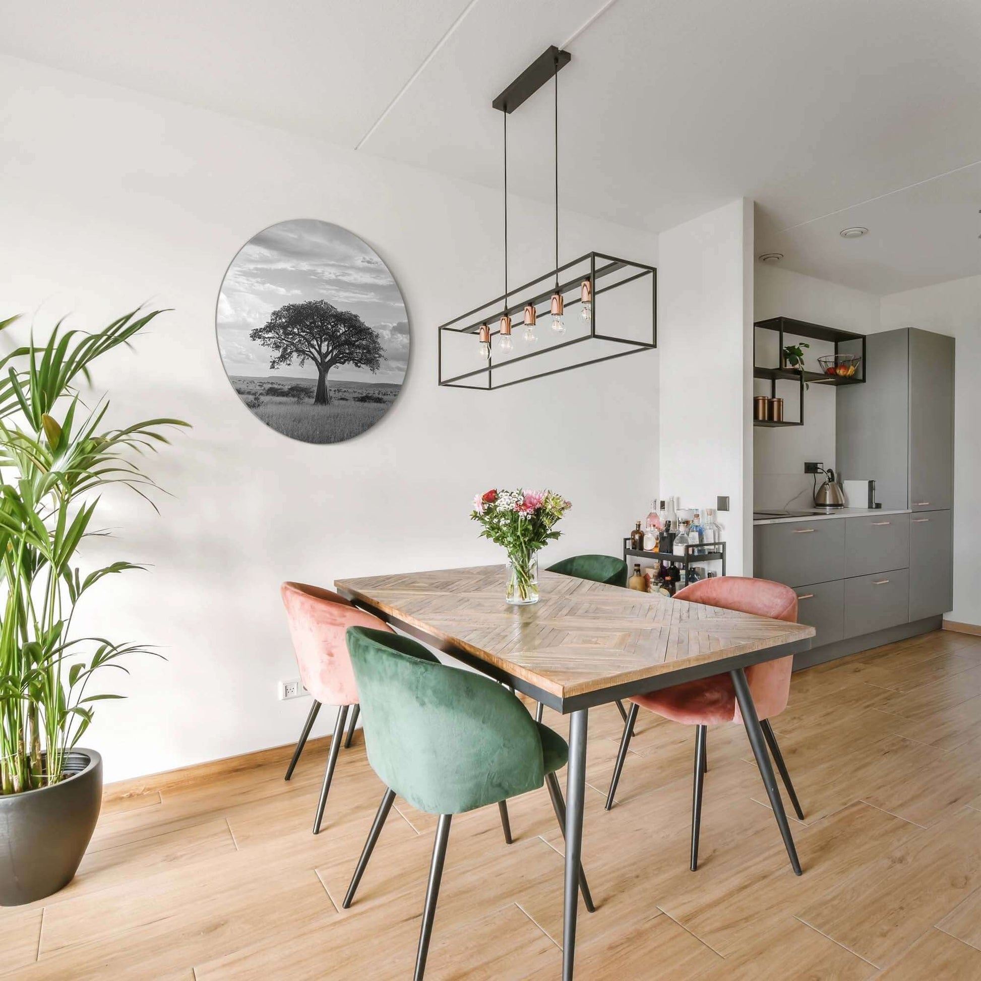 Lone Horizon - Muurcirkel in een moderne eetkamer, een zwart-wit wandcirkel met solitaire boom zichtbaar aan de muur.