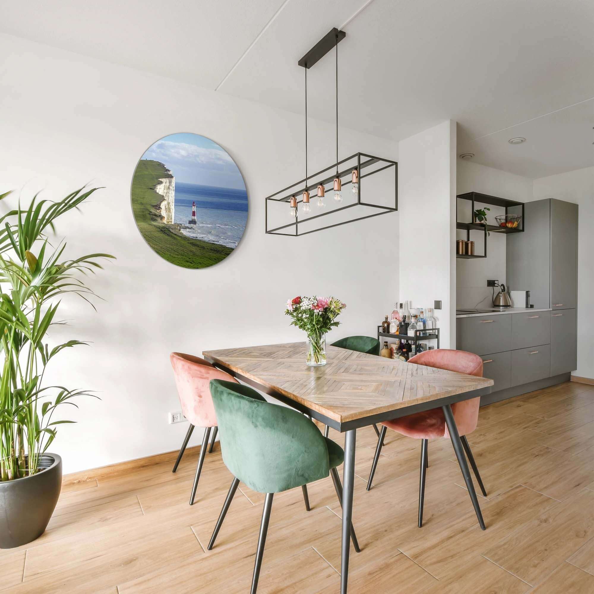 Solitary Heights – Muurcirkel in een moderne eetkamer met planten en kleurrijke stoelen.