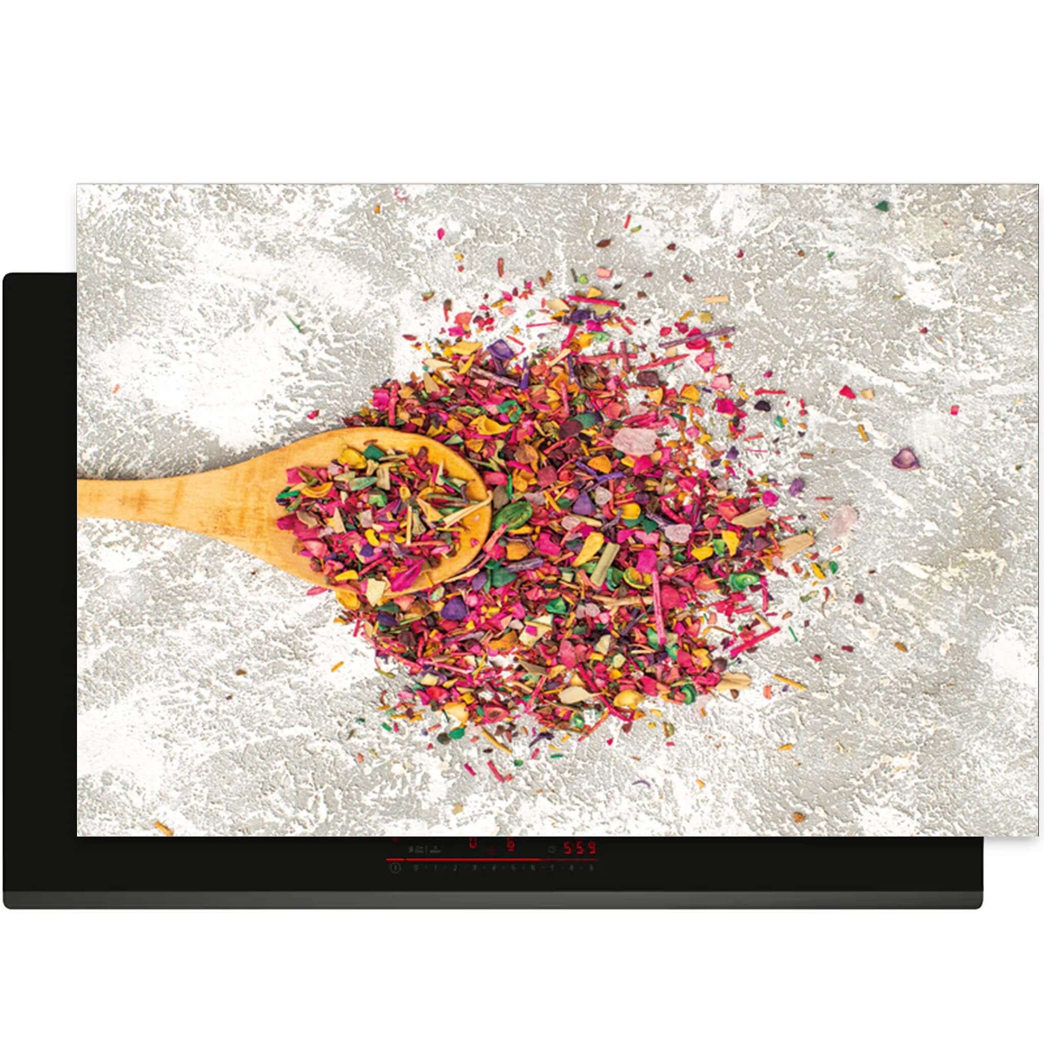 Bovenaanzicht van de Spice Delight inductiebeschermer met kleurrijke kruiden en houten lepel
